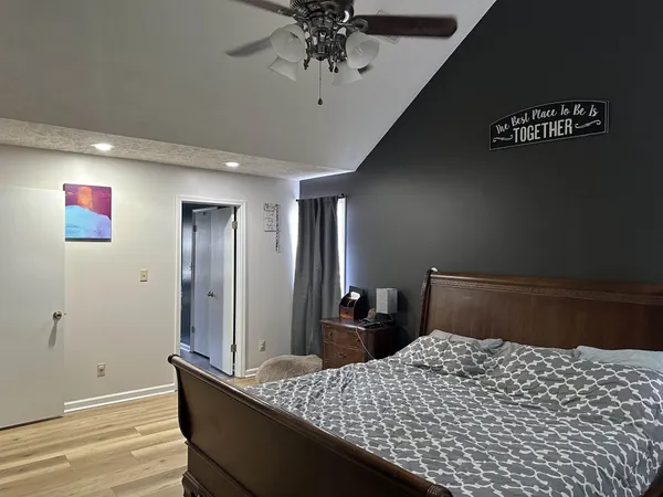 a bedroom with a bed and a dresser