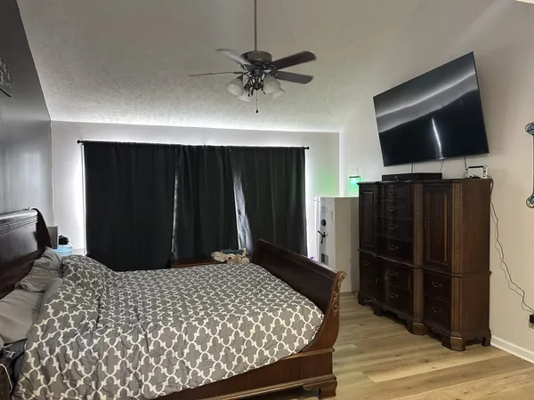 a bedroom with a bed and a television