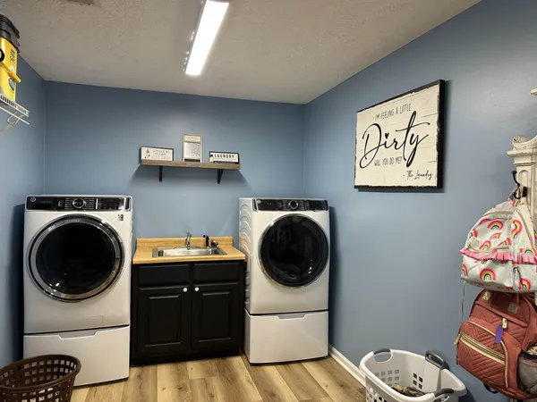 a utility room with sink dryer and washer