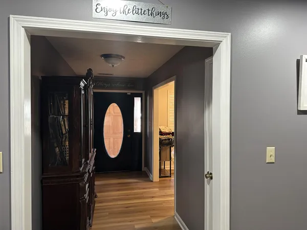 a front view of a house with wooden floor and a window