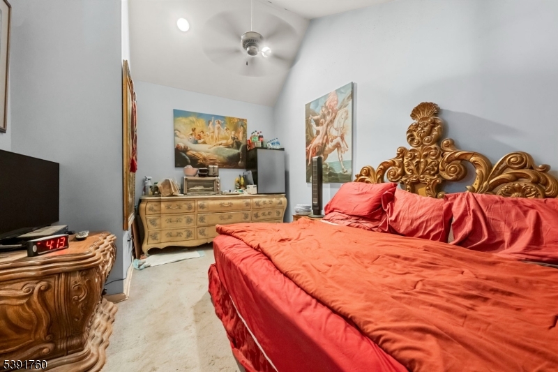 95 Quartz Lane Paterson, NJ 07501 - Photo 13 of 13 a bedroom with a bed and flat screen tv