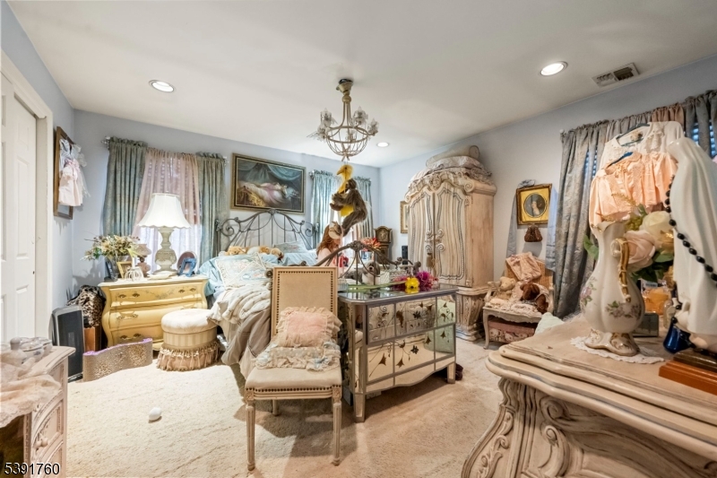 95 Quartz Lane Paterson, NJ 07501 - Photo 10 of 13 a living room with furniture a chandelier and a fireplace