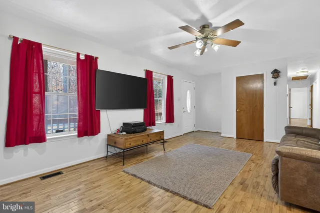 a kitchen with a refrigerator and countertop white cabinets