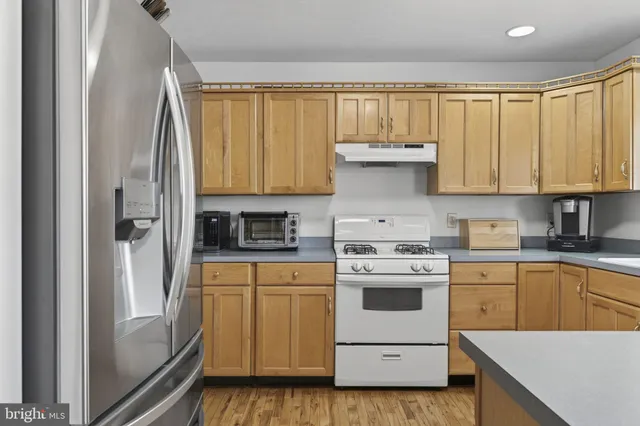 a kitchen with a sink cabinets and wooden floor