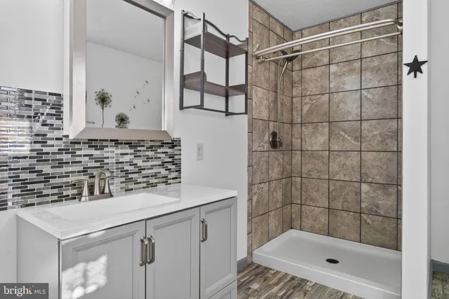 a bedroom with a bed dresser and a window