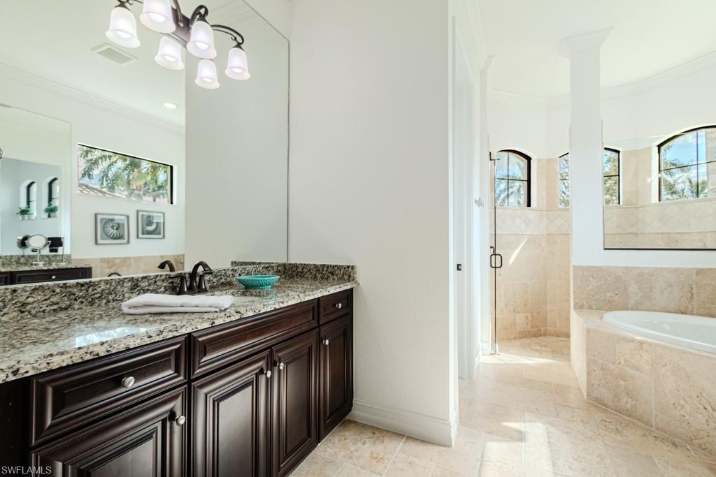 3273 Runaway Lane Naples, FL 34114 - Photo 12 of 45 a bathroom with a granite countertop sink a mirror and a bathtub