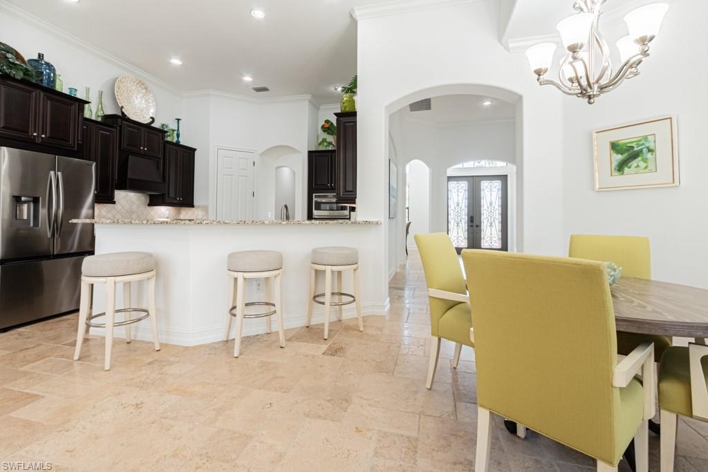 3273 Runaway Lane Naples, FL 34114 - Photo 15 of 45 a large kitchen with a table and chairs