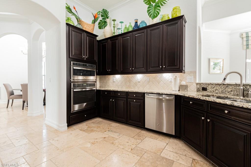 3273 Runaway Lane Naples, FL 34114 - Photo 19 of 45 a kitchen with granite countertop a refrigerator and a stove top oven