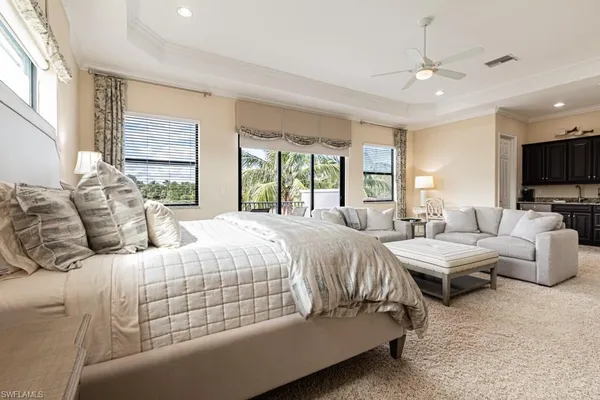 a living room with furniture a flat screen tv and a large window