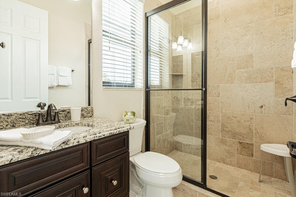 3273 Runaway Lane Naples, FL 34114 - Photo 30 of 45 a bathroom with a sink and mirror with toilet