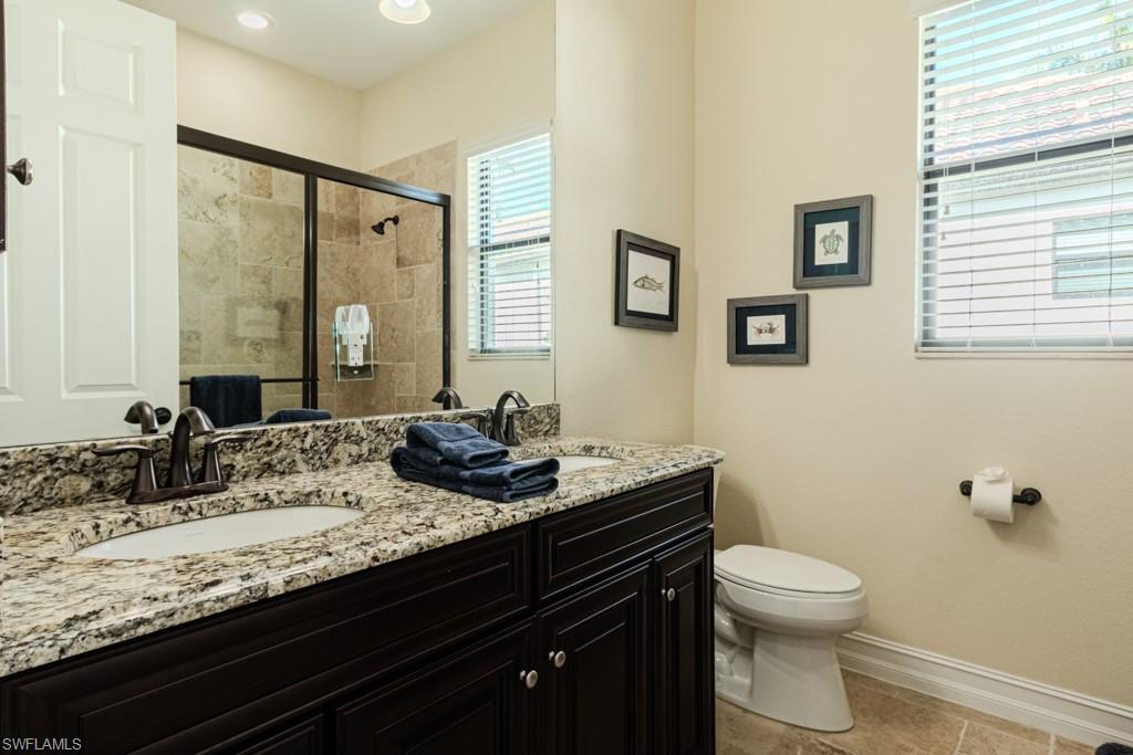 3273 Runaway Lane Naples, FL 34114 - Photo 34 of 45 a bathroom with a granite countertop sink a toilet and a mirror