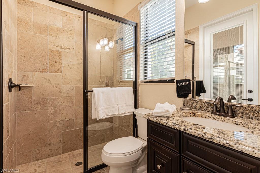 3273 Runaway Lane Naples, FL 34114 - Photo 37 of 45 a bathroom with a granite countertop sink toilet and shower
