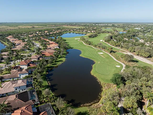 an aerial view of ocean residential house with outdoor space and trees all around
