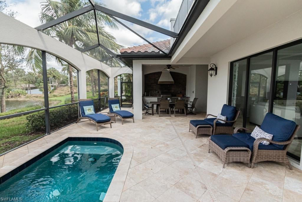3273 Runaway Lane Naples, FL 34114 - Photo 41 of 45 a living room with patio furniture and a floor to ceiling window