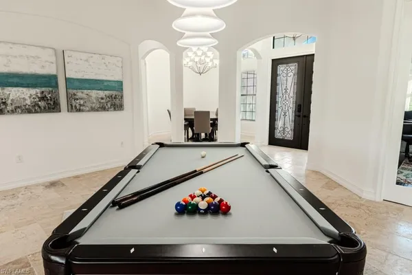 a spacious bedroom with a bed and a flat screen tv
