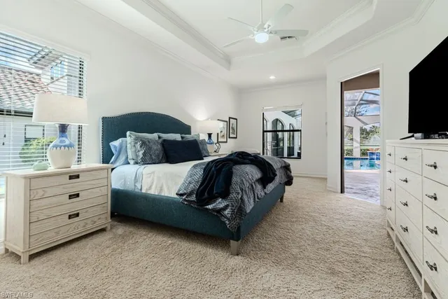 a spacious bedroom with a bed and a flat screen tv