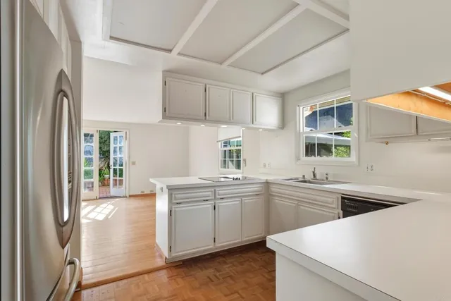 a kitchen with a sink stove and refrigerator
