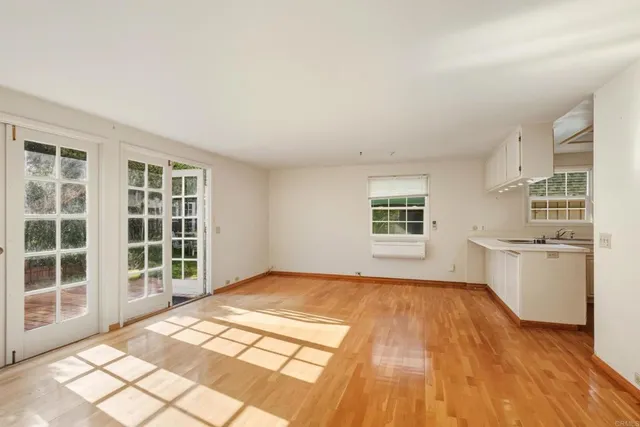 a view of a kitchen with wooden floor and a sink