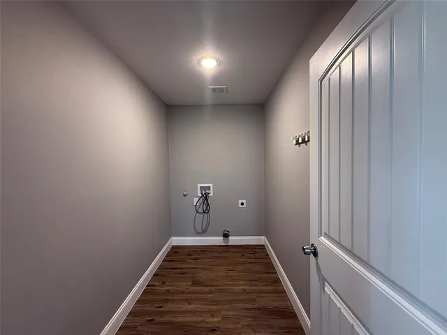a view of a livingroom with wooden floor and staircase