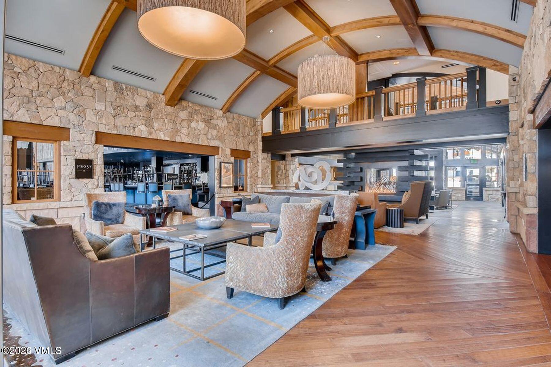 16 Vail Road, Unit 222 Vail, CO 81657 - Photo 4 of 6 a living room with lots of furniture and a wooden floor