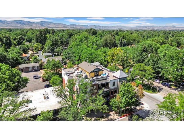 a picture of a building with a garden and plants