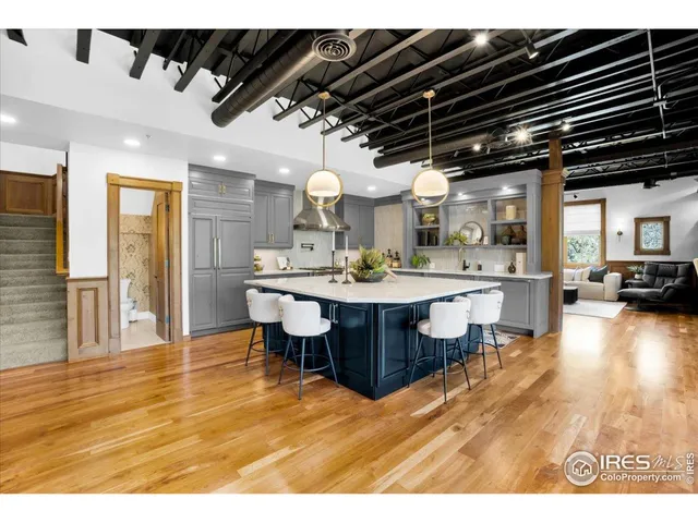 a dining hall with stainless steel appliances kitchen island a chandelier
