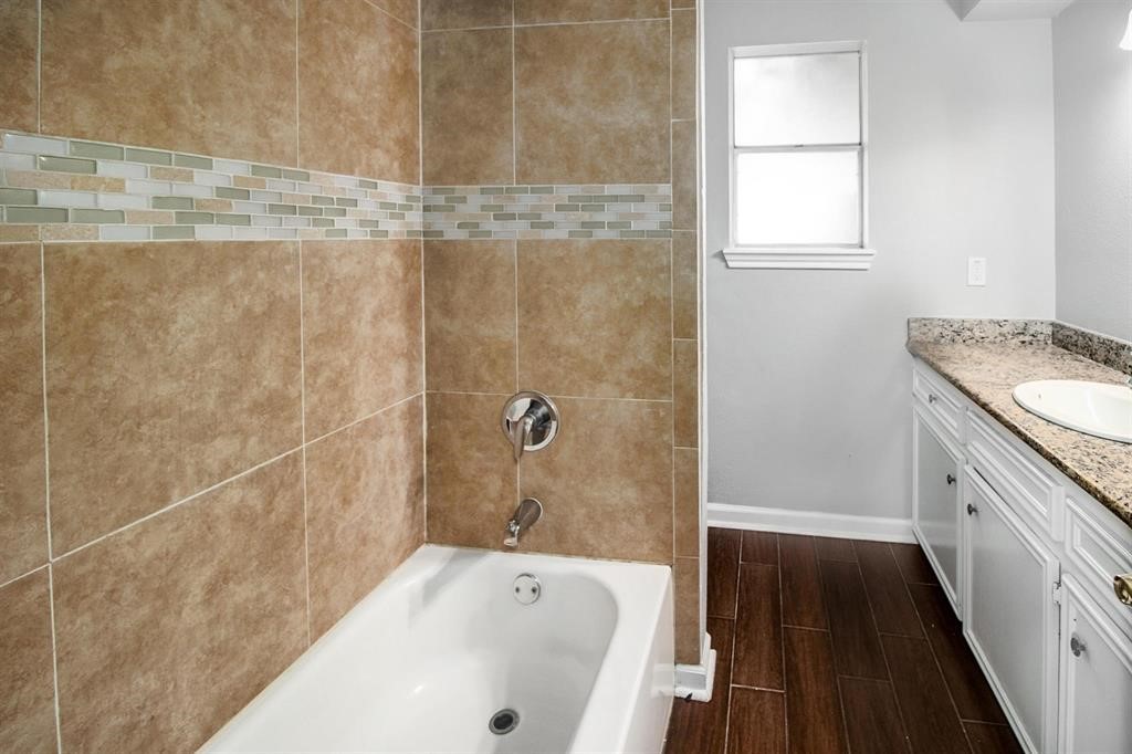 22603 Pine Mist Lane Spring, TX 77373 - Photo 17 of 26 a bathroom with a granite countertop bathtub sink vanity and window