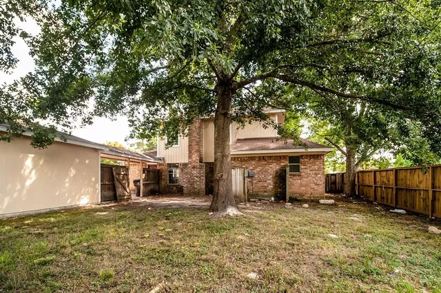 front view of a house with a tree