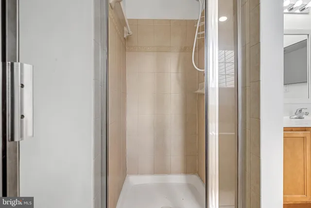 a bathroom with a glass shower door