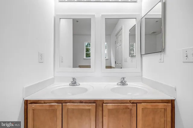 a bathroom with a granite countertop sink a mirror and a