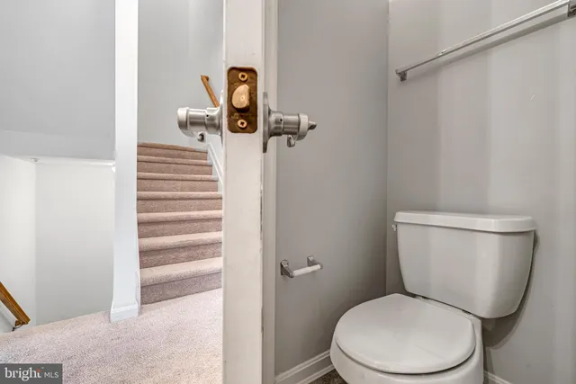 a white toilet sitting next to a bathroom