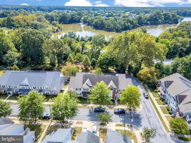 an aerial view of multiple houses with yard