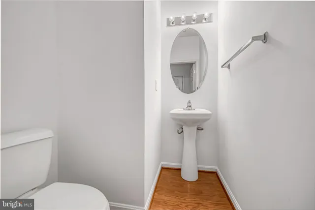 a bathroom with a sink toilet and a mirror