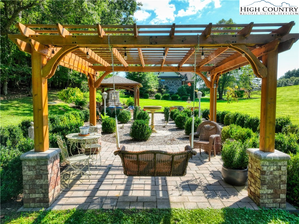 330 Crain Branch Lane Jefferson, NC 28640 - Photo 16 of 45 a backyard of a house with a fountain table and chairs