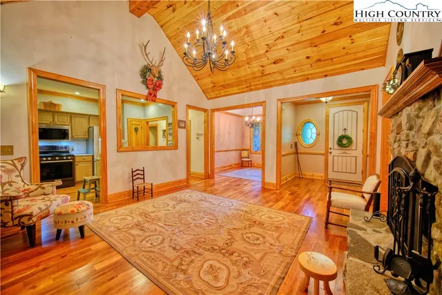 a bedroom with a bed and dresser with wooden floor