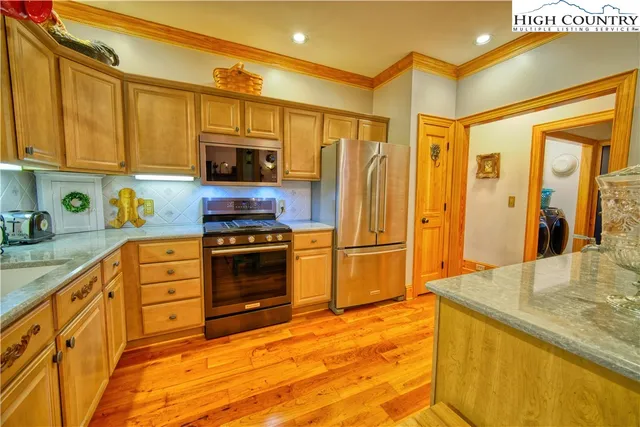 a kitchen with stainless steel appliances granite countertop a stove and a sink