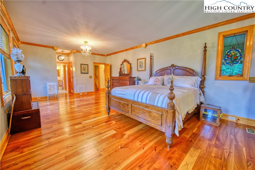 330 Crain Branch Lane Jefferson, NC 28640 - Photo 37 of 45 a bedroom with a bed and wooden floor