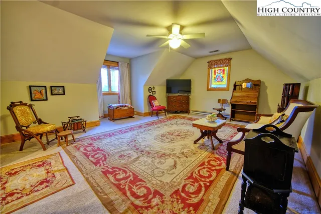 a bedroom with furniture and a mirror