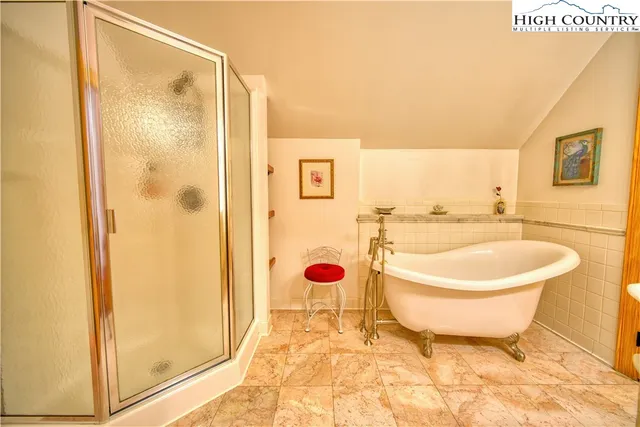 a bathroom with a sink mirror bathtub and toilet