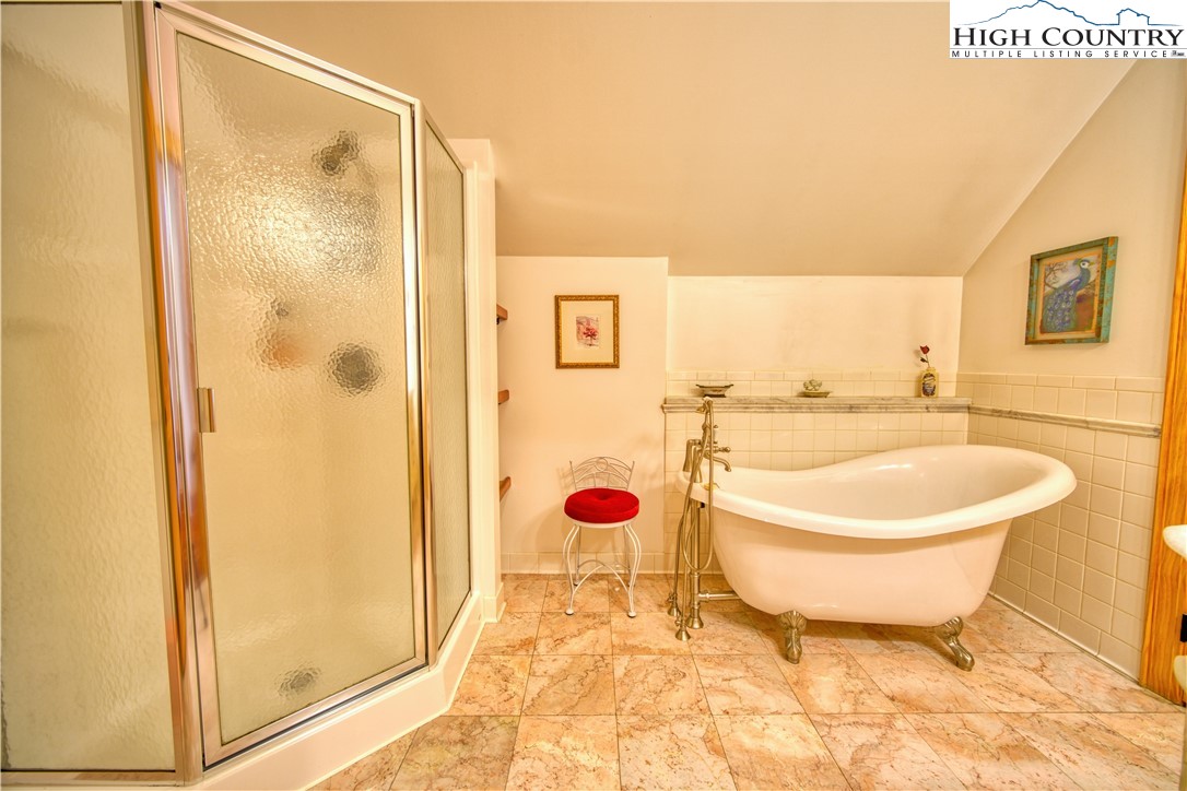 330 Crain Branch Lane Jefferson, NC 28640 - Photo 44 of 45 a bathroom with a sink mirror bathtub and toilet