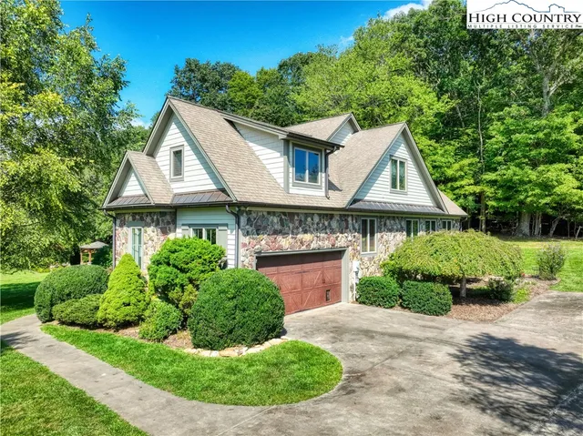 a aerial view of a house with a yard and potted plants