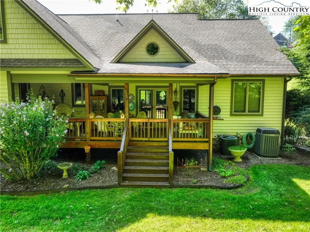 a front view of a house with garden and sitting area