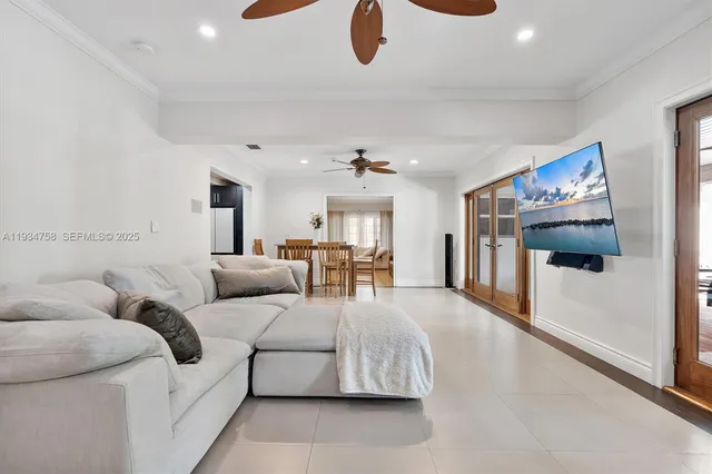 a kitchen with stainless steel appliances kitchen island granite countertop a refrigerator a stove a sink a dining table and chairs with wooden floor