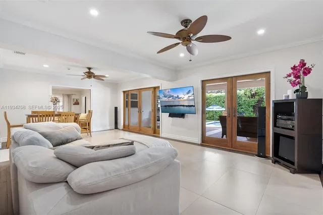 a kitchen with stainless steel appliances kitchen island granite countertop a table chairs and a refrigerator