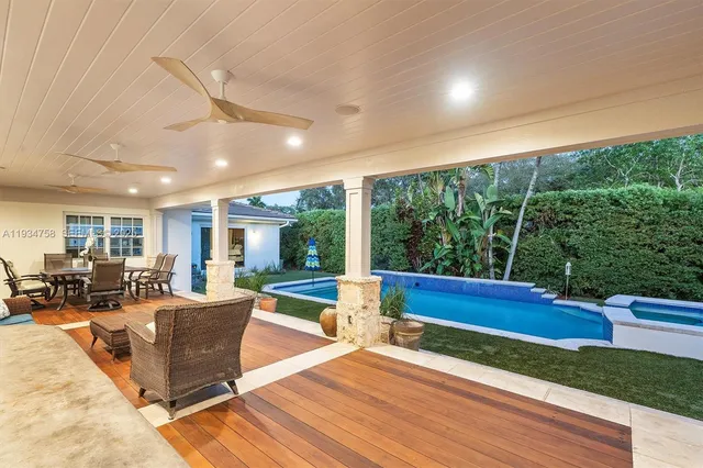 a kitchen with stainless steel appliances granite countertop a sink a stove and a refrigerator