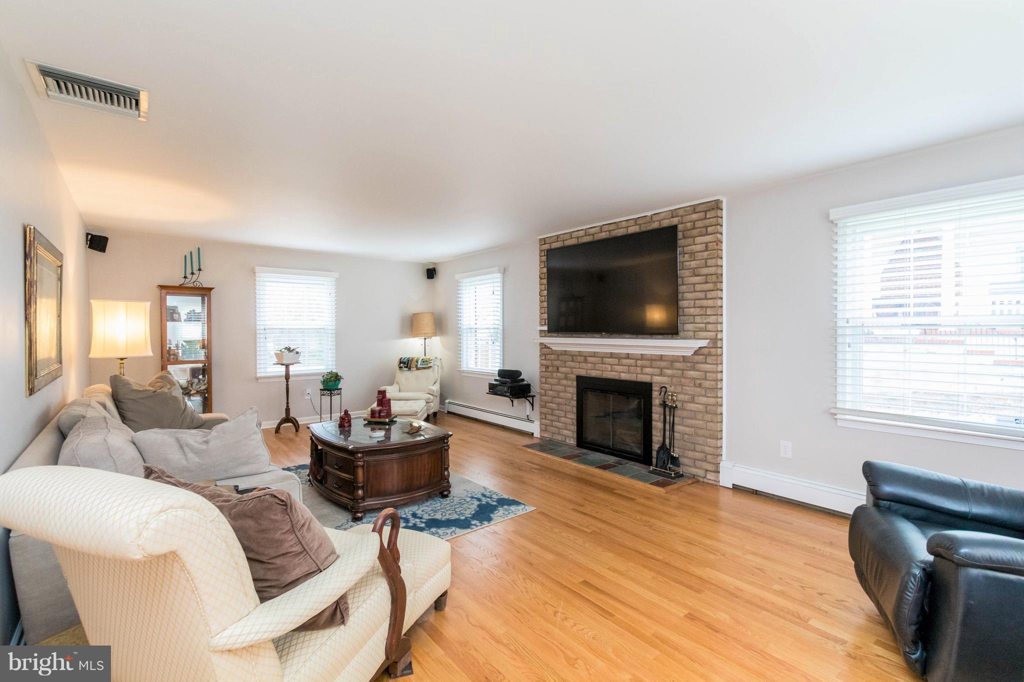 239 Ridgeway Road Catonsville, MD 21228 - Photo 5 of 30 a living room with furniture a fireplace and a flat screen tv