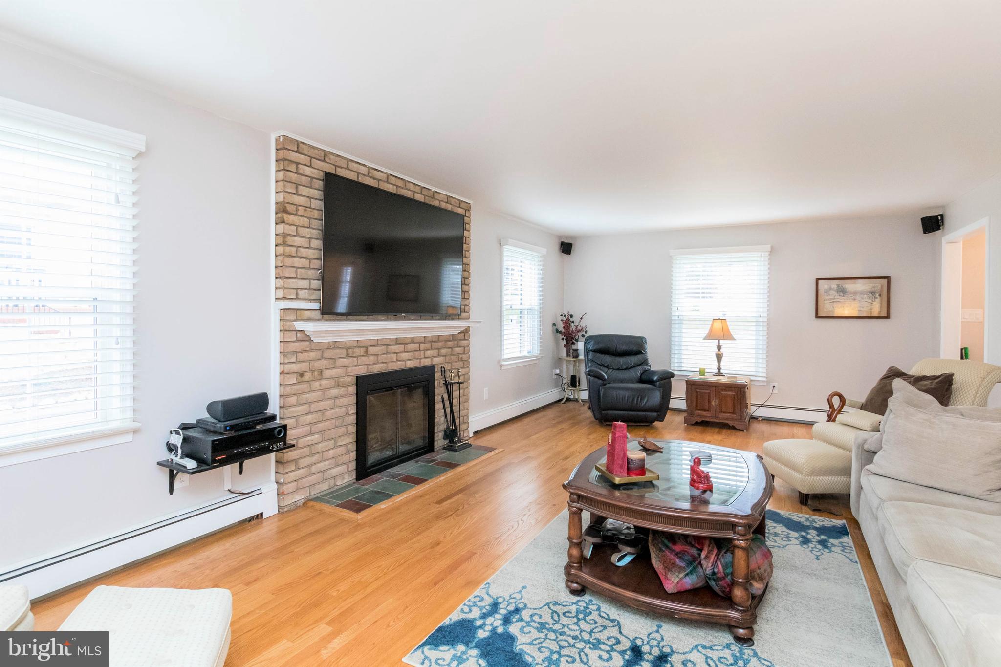 239 Ridgeway Road Catonsville, MD 21228 - Photo 6 of 30 a living room with furniture a fireplace and a flat screen tv