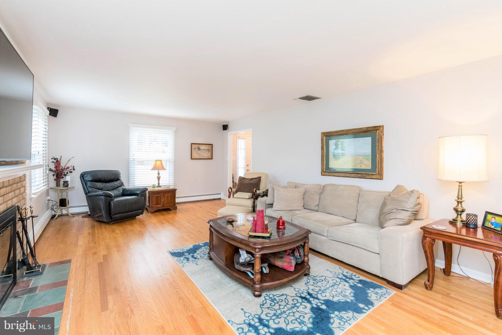 239 Ridgeway Road Catonsville, MD 21228 - Photo 7 of 30 a living room with furniture or couch and a dining table with wooden floor