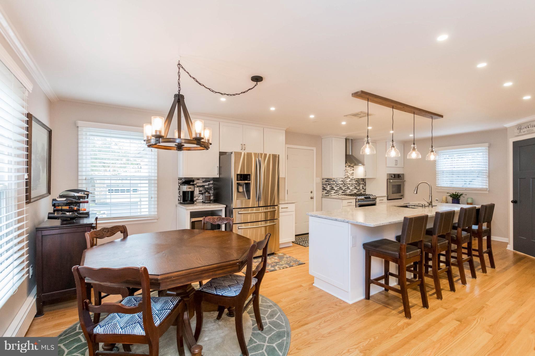 239 Ridgeway Road Catonsville, MD 21228 - Photo 8 of 30 a kitchen with kitchen island a dining table and chairs
