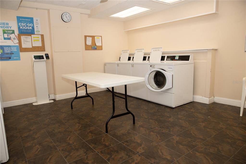 8911 Blind Pass Road, Unit 220 St. Pete Beach, FL 33706 - Photo 62 of 67 a utility room with dryer and washer